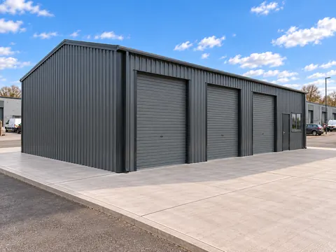 Roller shutter doors on a dark clad steel framed vehicle unit