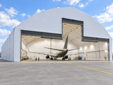 A clear span hangar seen from the side, showing its length