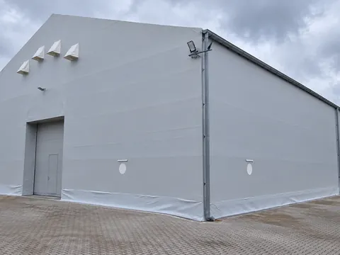 A PVC clad temporary building seen from the corner
