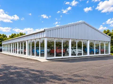 A glazed steel framed building used as a vehicle showroom