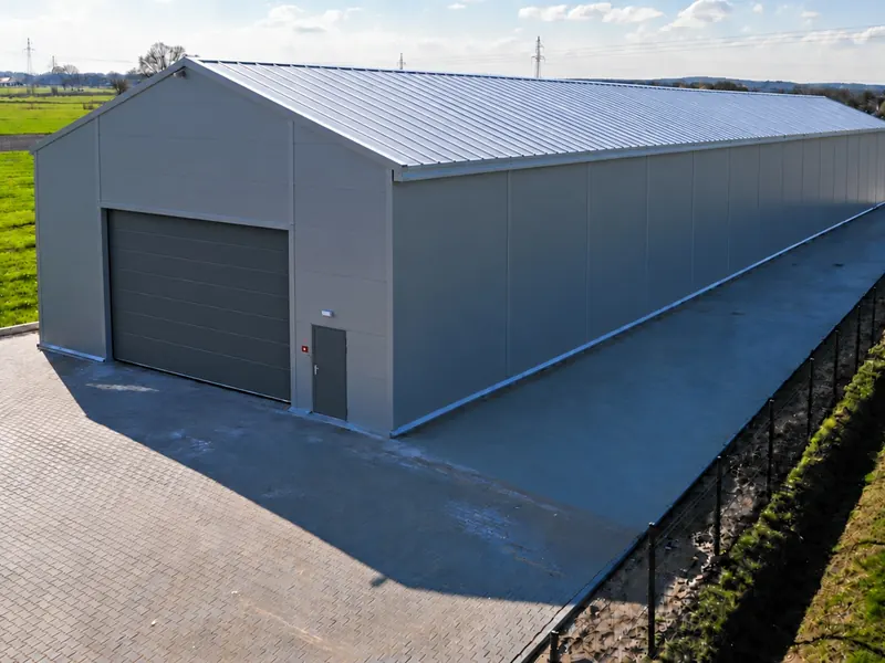A white steel-framed temporary building with a PVC roof