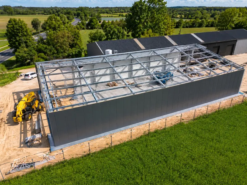 Inside a semi-permanent building, the steel frame and lined walls visible along the length