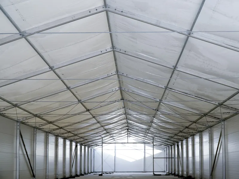 Interior of a clear span temporary building showing the full uninterrupted width