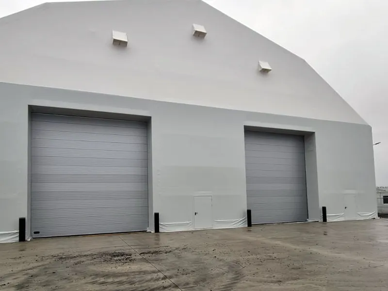 White temporary warehouse building with two roller shutter doors