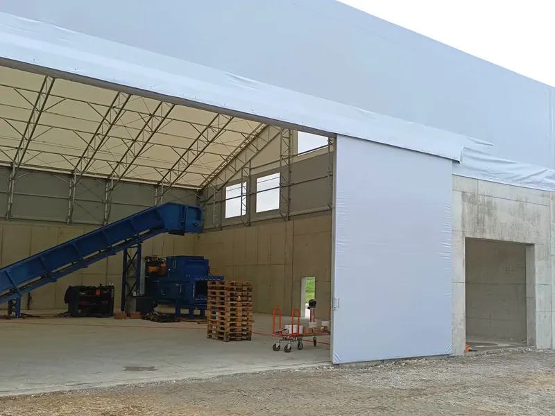 Temporary workshop interior with wide door access