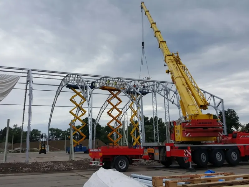 Crane erecting a temporary building frame on a construction site